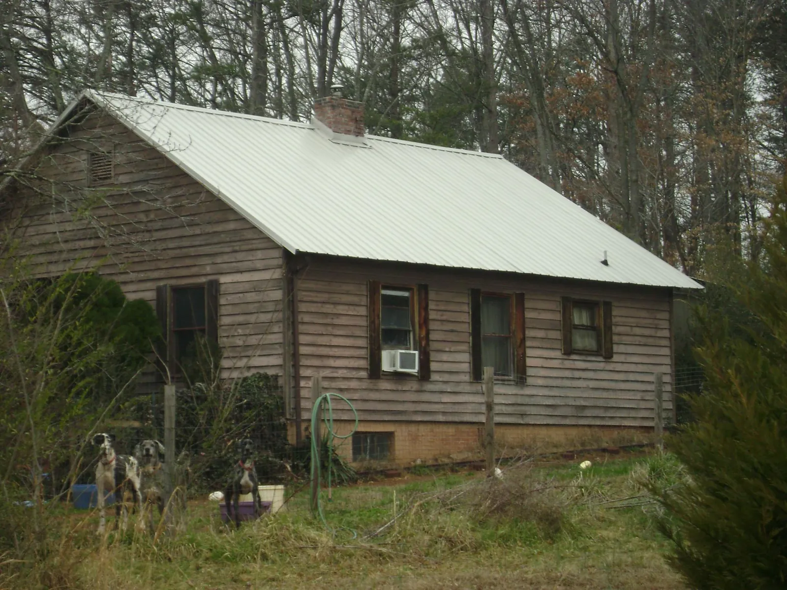 White metal roof on an old wood sided farmhouse, from a Metal Roof Installation job in Vermillion